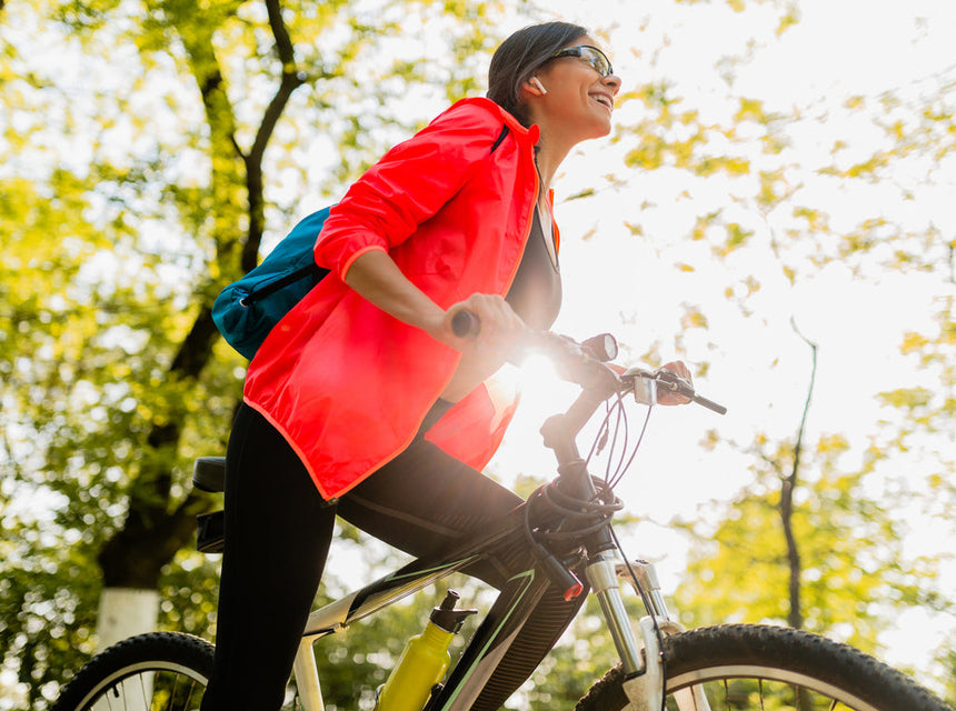 Happy woman riding bicylce in the park