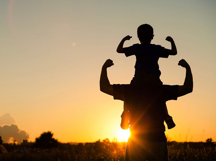 Sunset with father carrying sun on his shoulders