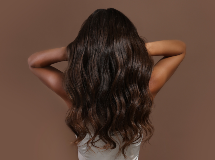 Woman with long brown, shiny, wavy hair