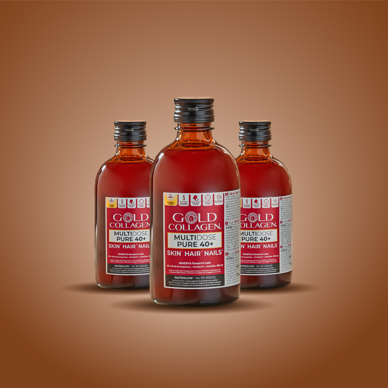Three bottles of Gold Collagen supplement on a brown background